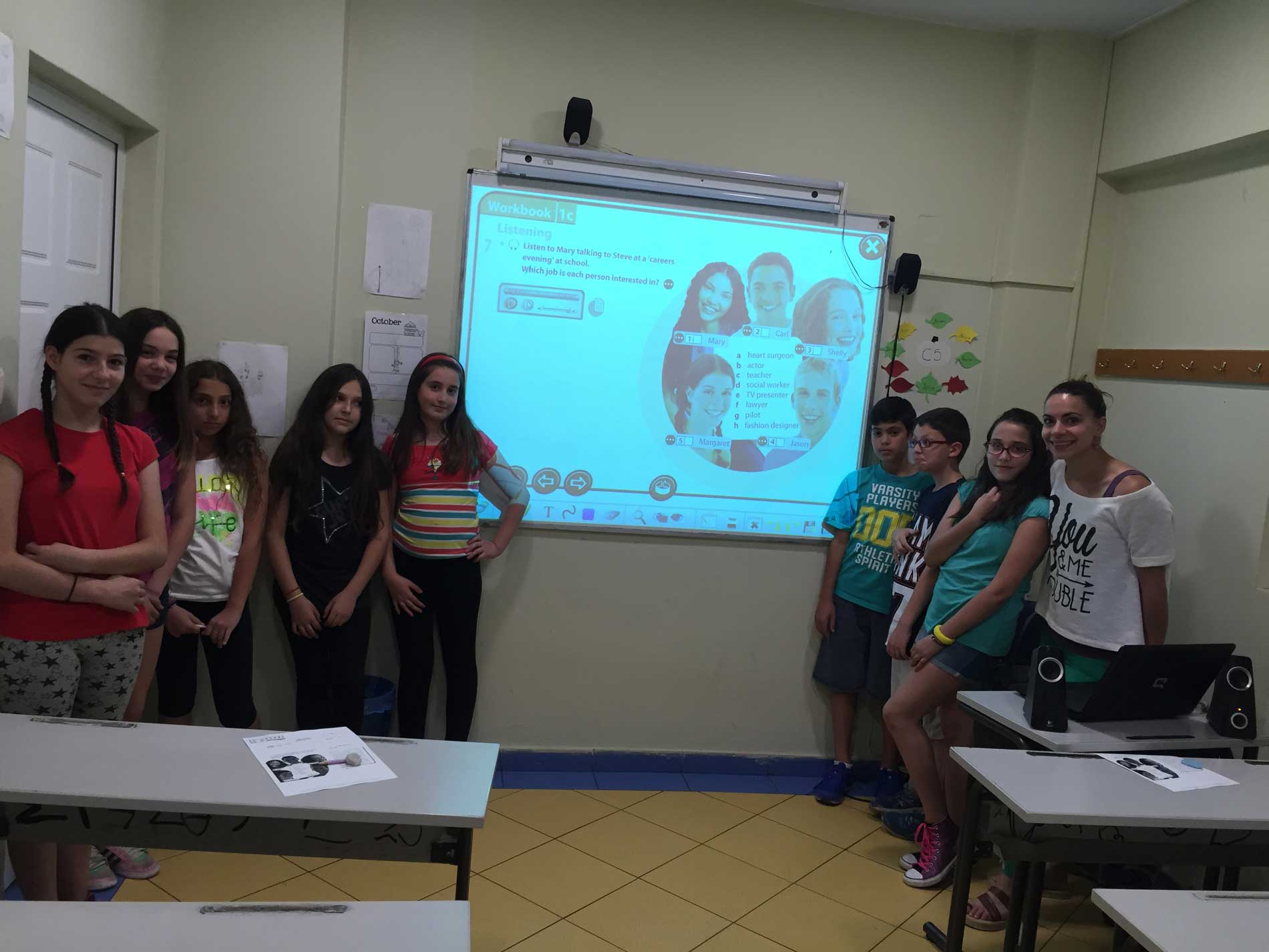 Teacher with students at the interactive board