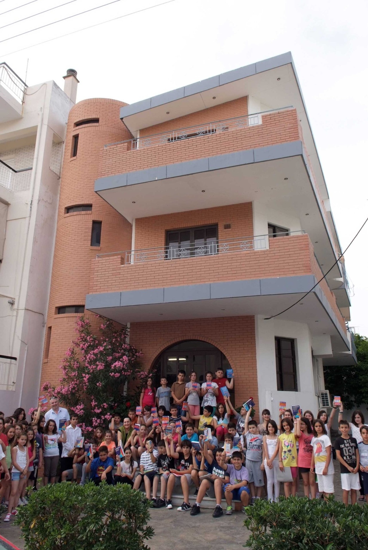 Students in front of the school with their books